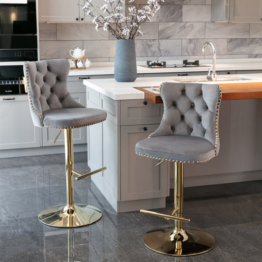 Elegant grey velvet bar stool with tufted back and gold trim