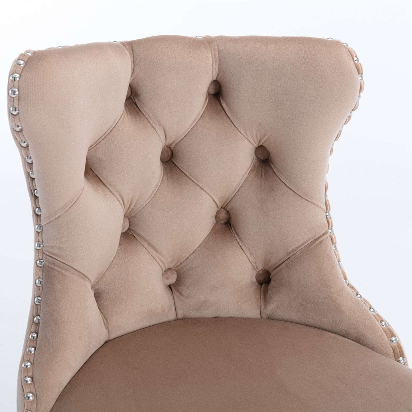 Beige velvet upholstered dining chair with button tufting and silver nailhead trim