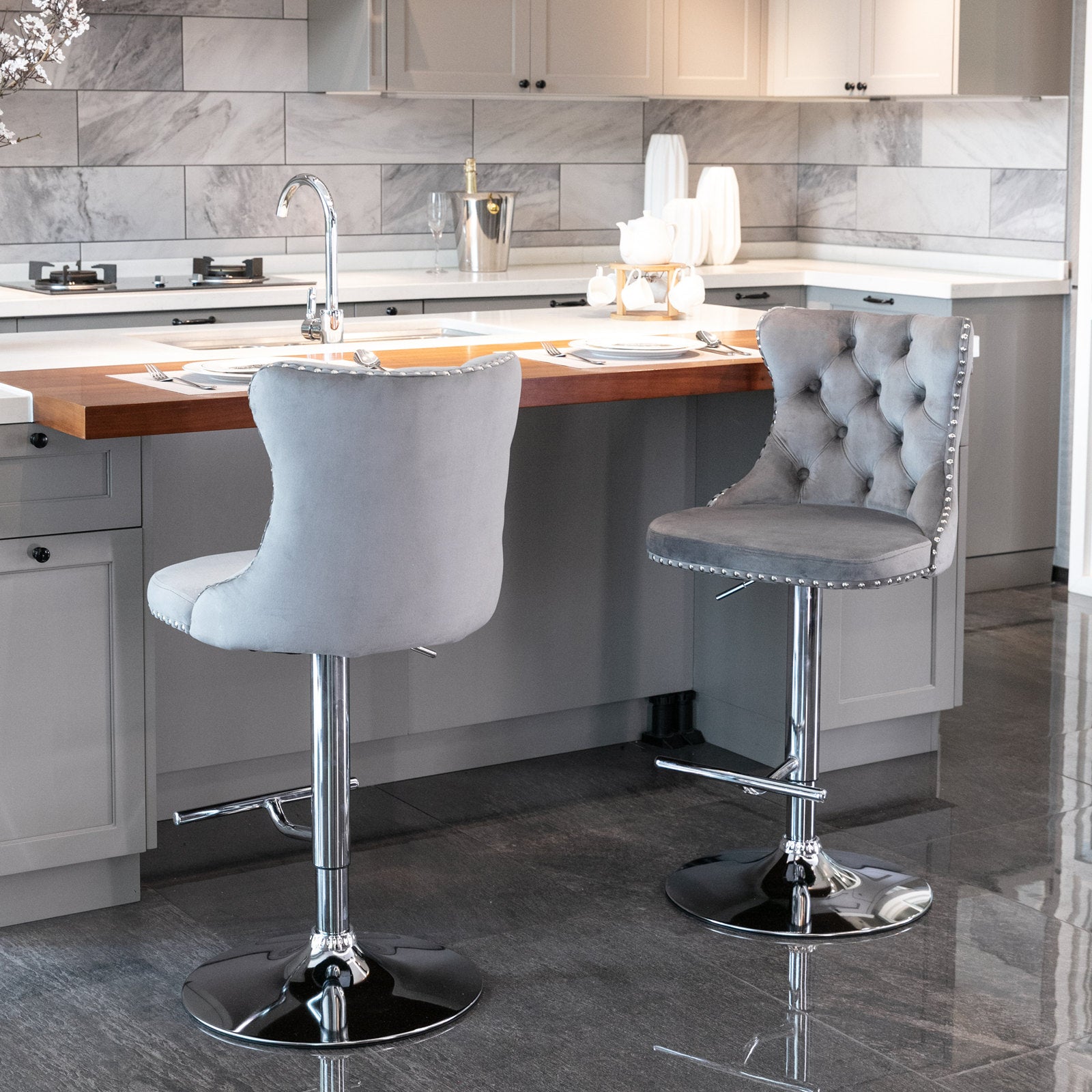 Tufted grey velvet bar stool with silver nailhead trim and chrome base
