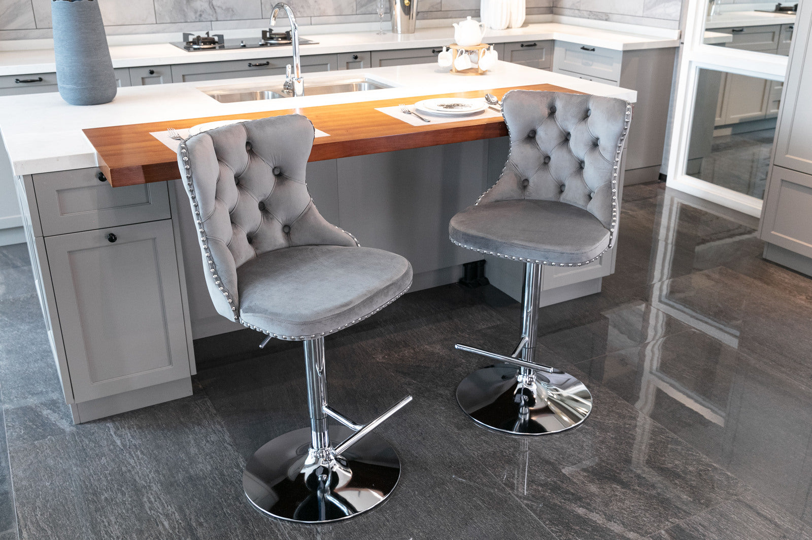 Tufted grey velvet bar stool with silver nailhead trim and chrome base