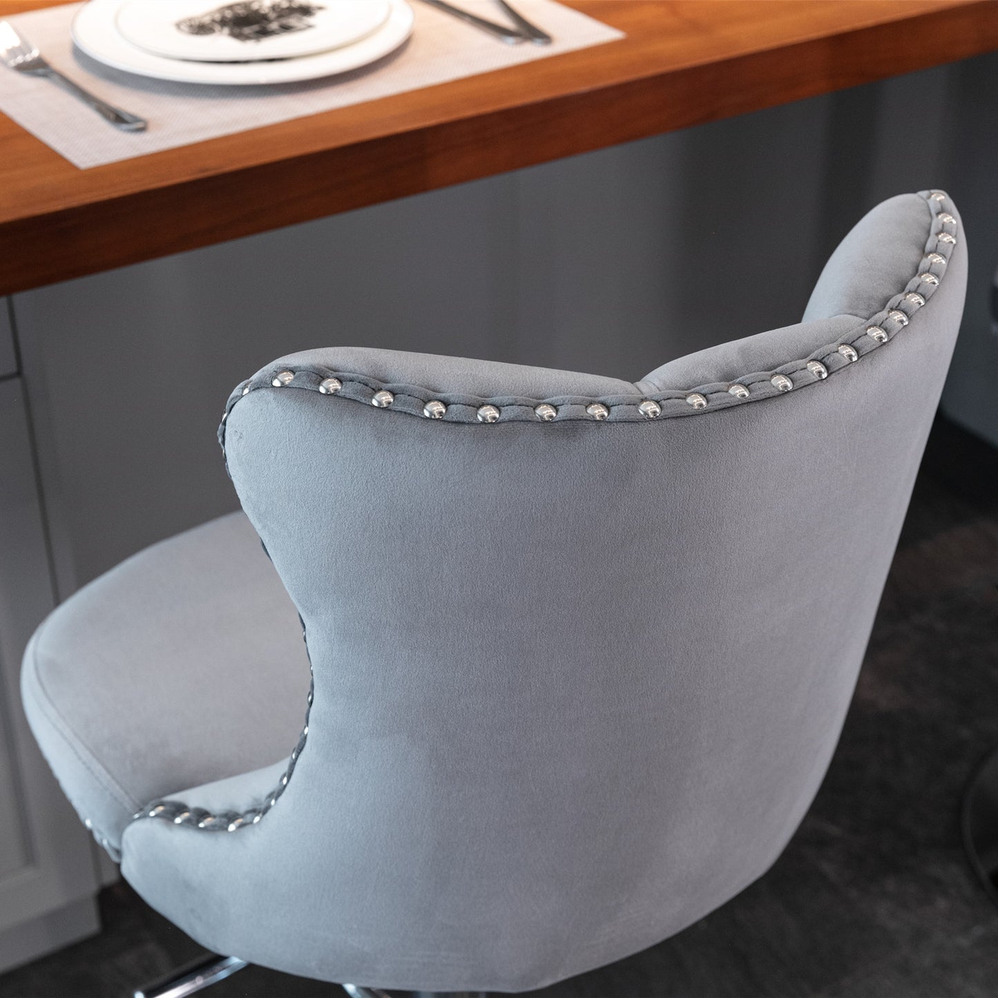 Gray velvet bar stool with silver nailhead trim accent