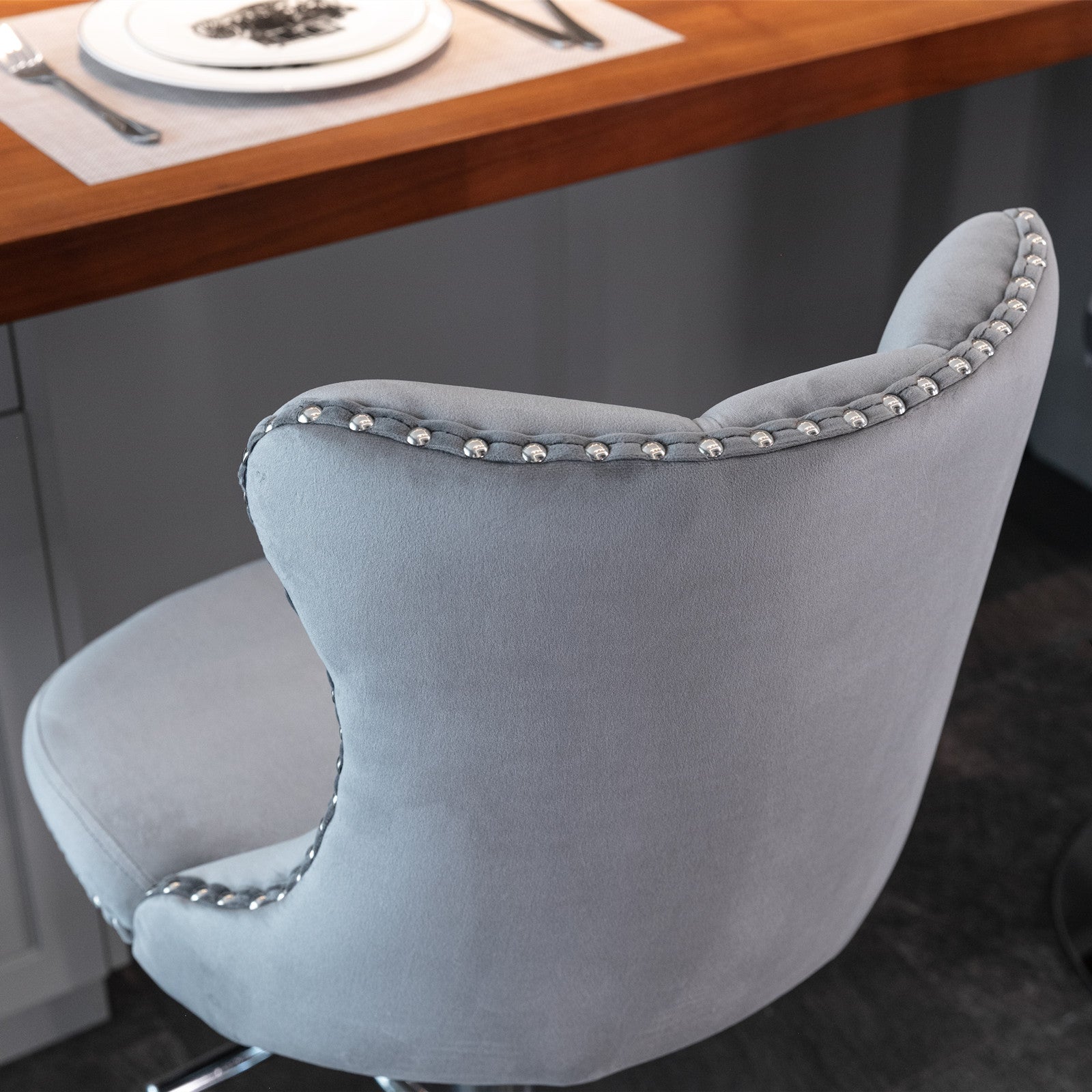 Gray velvet bar stool with silver nailhead trim accent