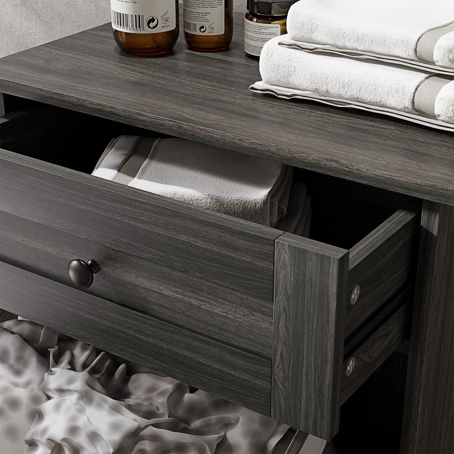 Dark grey wood nightstand with open drawer revealing towels
