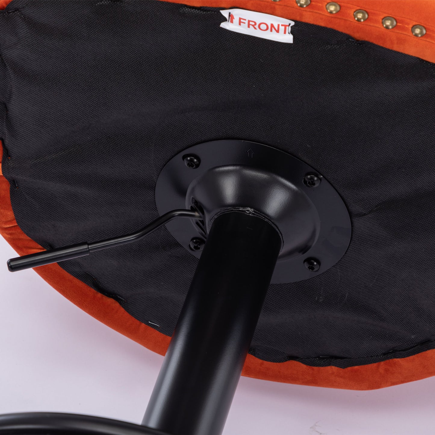 Orange velvet bar stool underside with black base and height adjustment lever