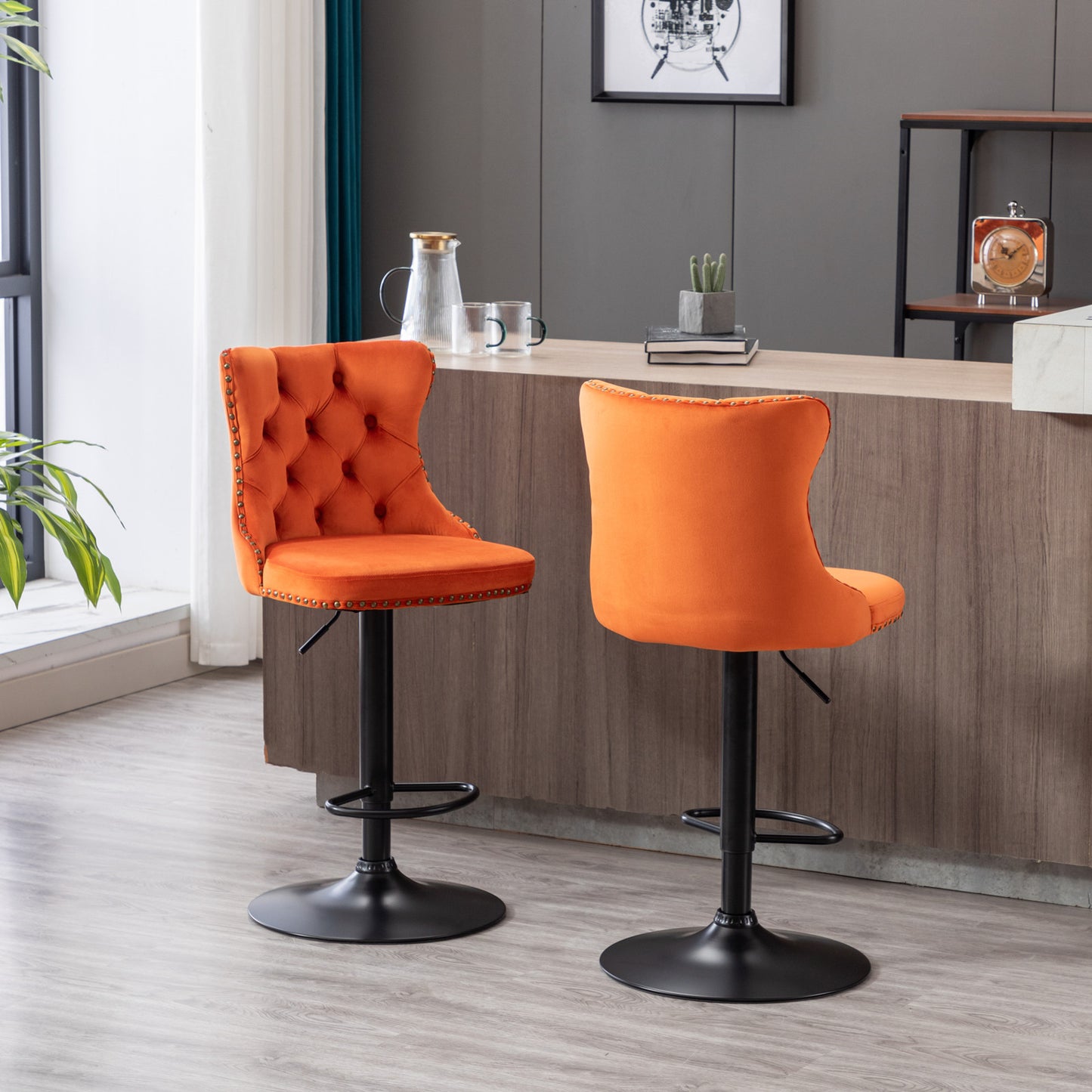Orange velvet tufted bar stool with brass nailhead trim and black base