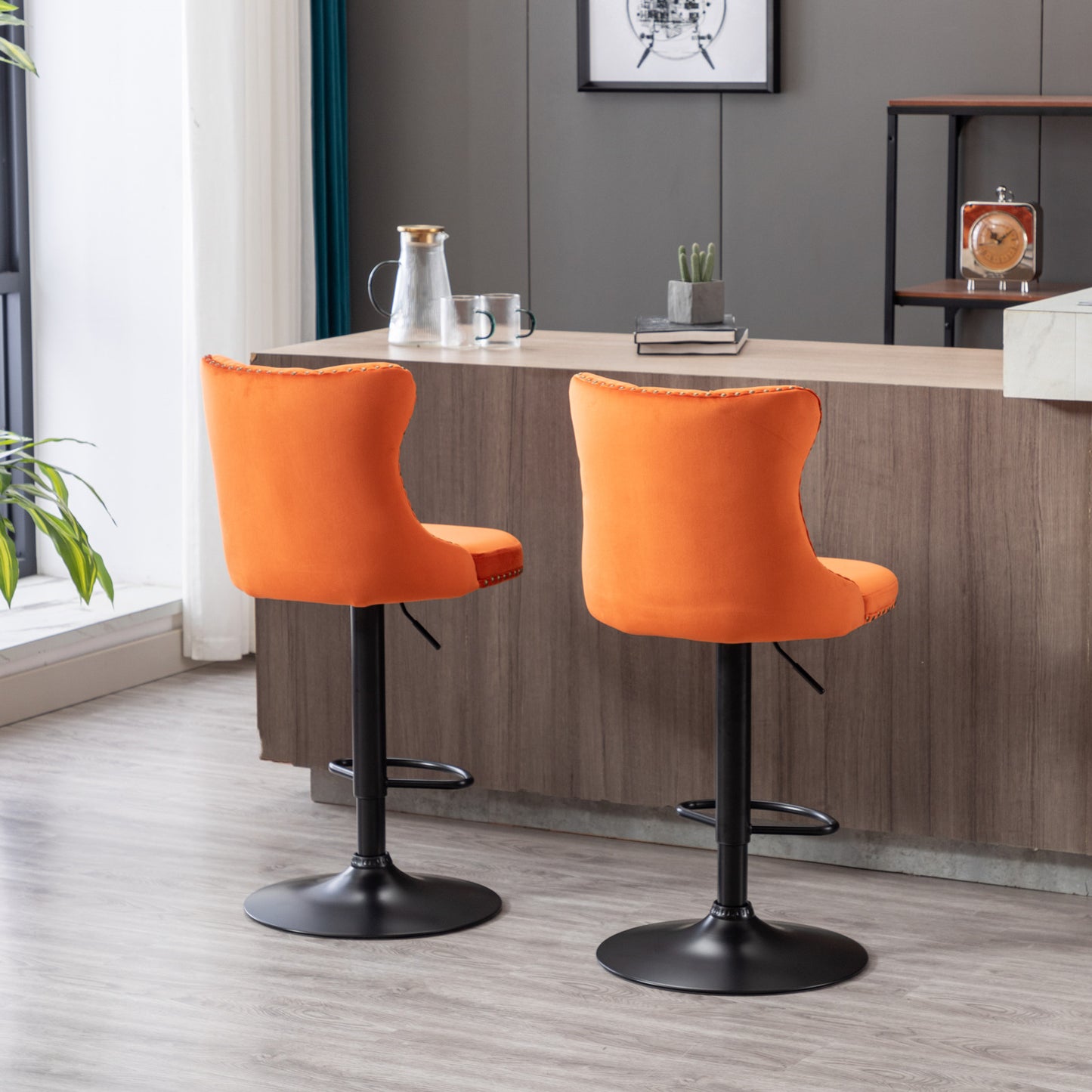 Orange velvet bar stool with adjustable height and black base