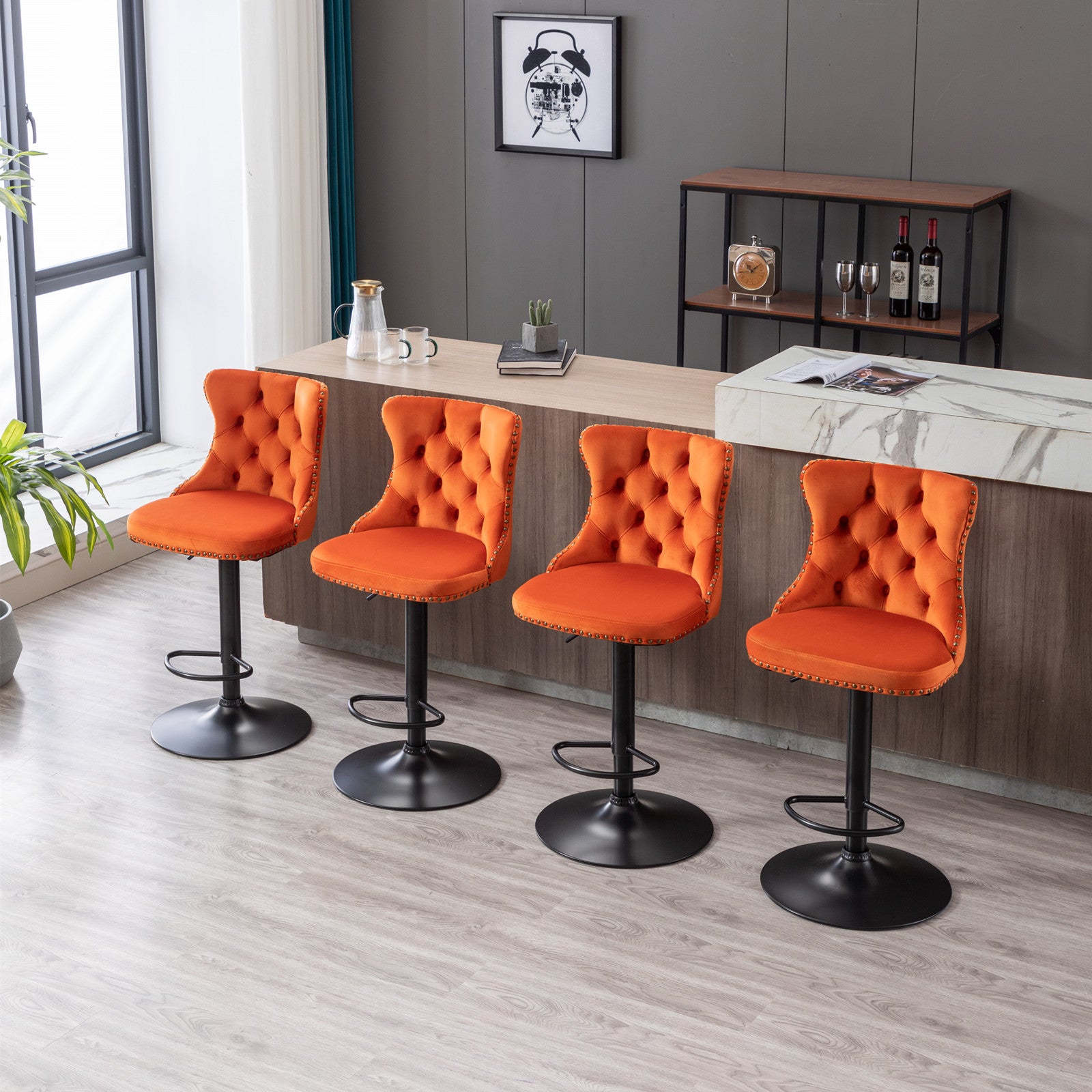 Four orange velvet tufted bar stools with nailhead trim and black bases
