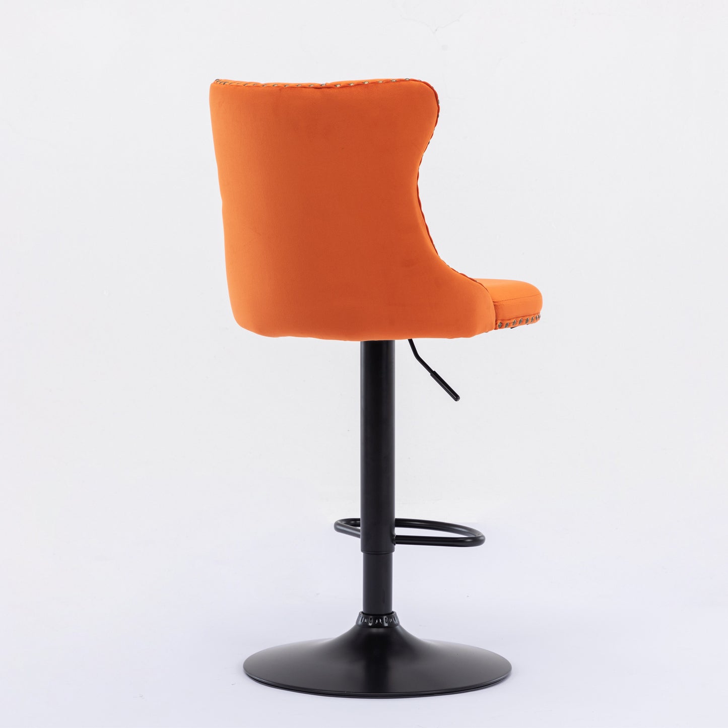 Orange velvet bar stool with black adjustable height base and footrest