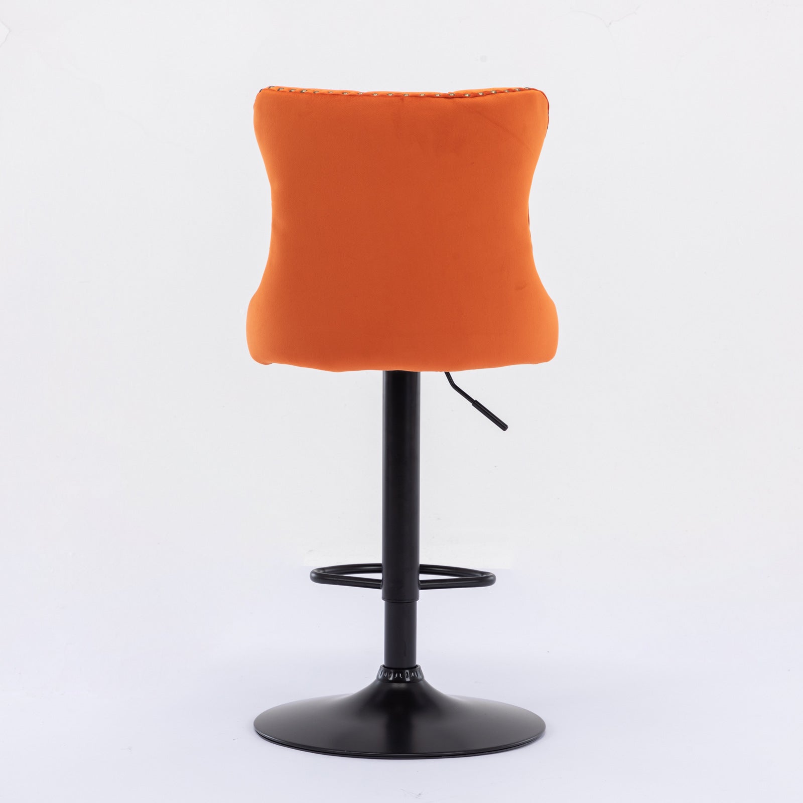 Adjustable orange velvet bar stool with chrome base and studded back