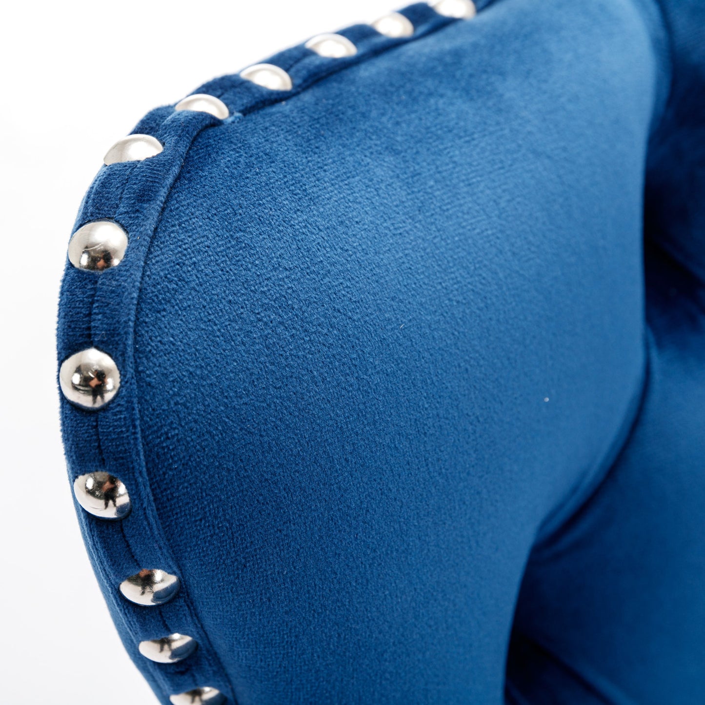 Deep blue velvet armchair with decorative silver nailhead trim