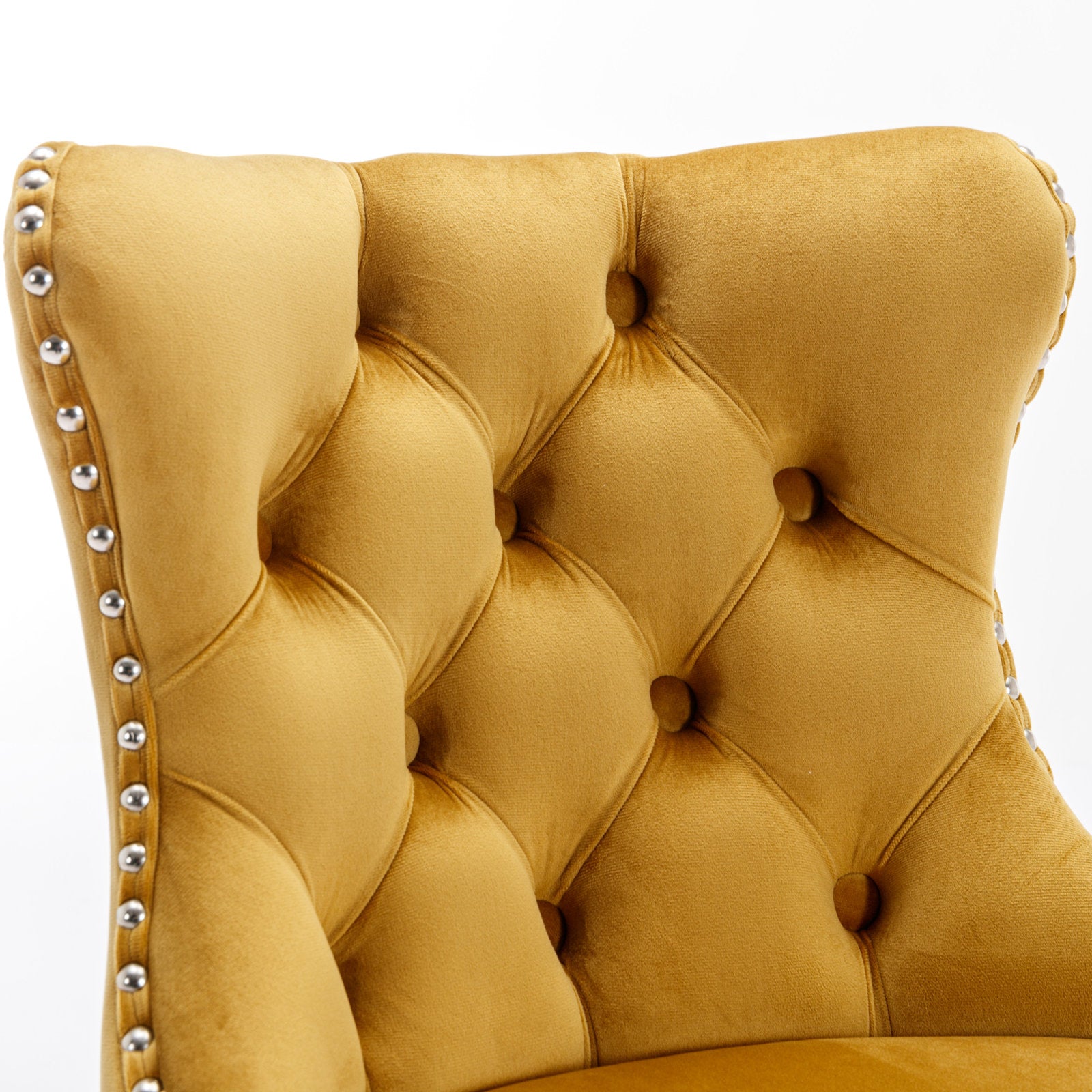 Yellow velvet armchair with tufted back and silver nailhead trim detail