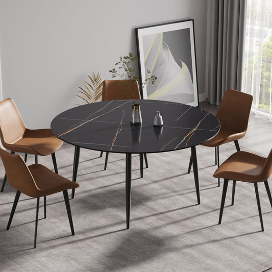 Black round marble dining table with gold veining and brown leather chairs