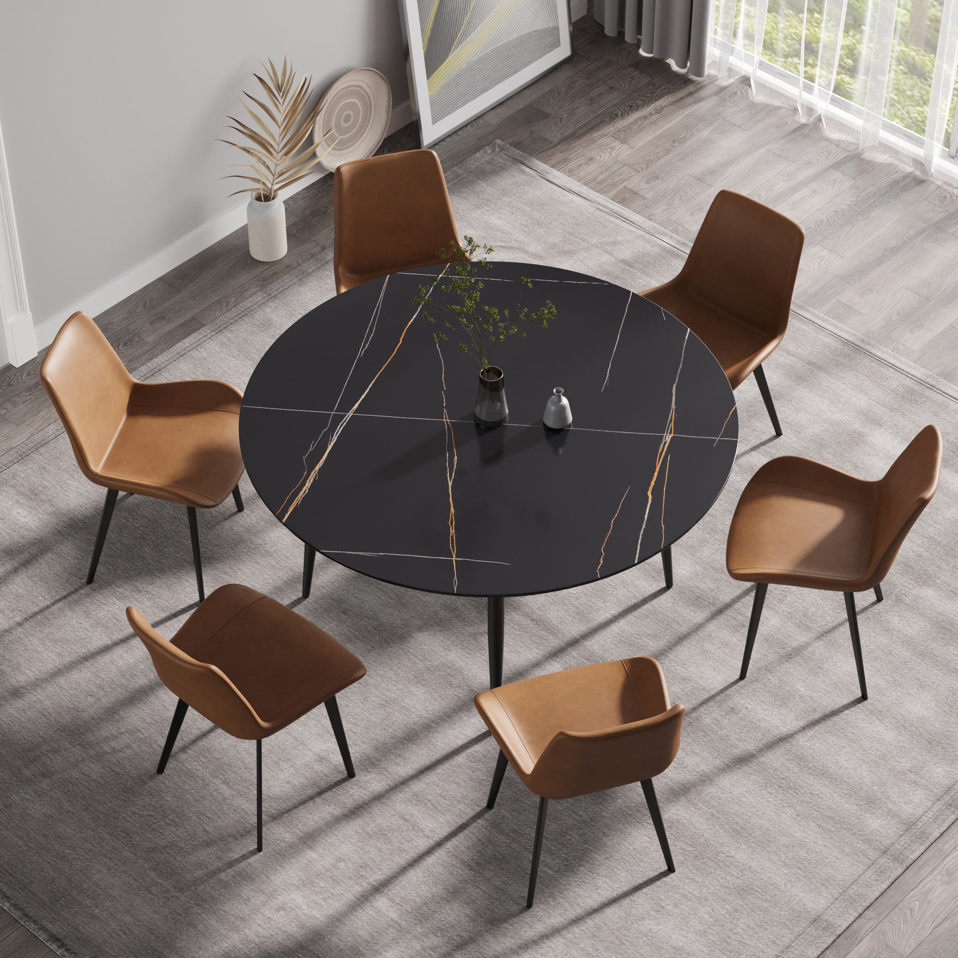 Round black marble dining table with gold veining and six brown leather chairs