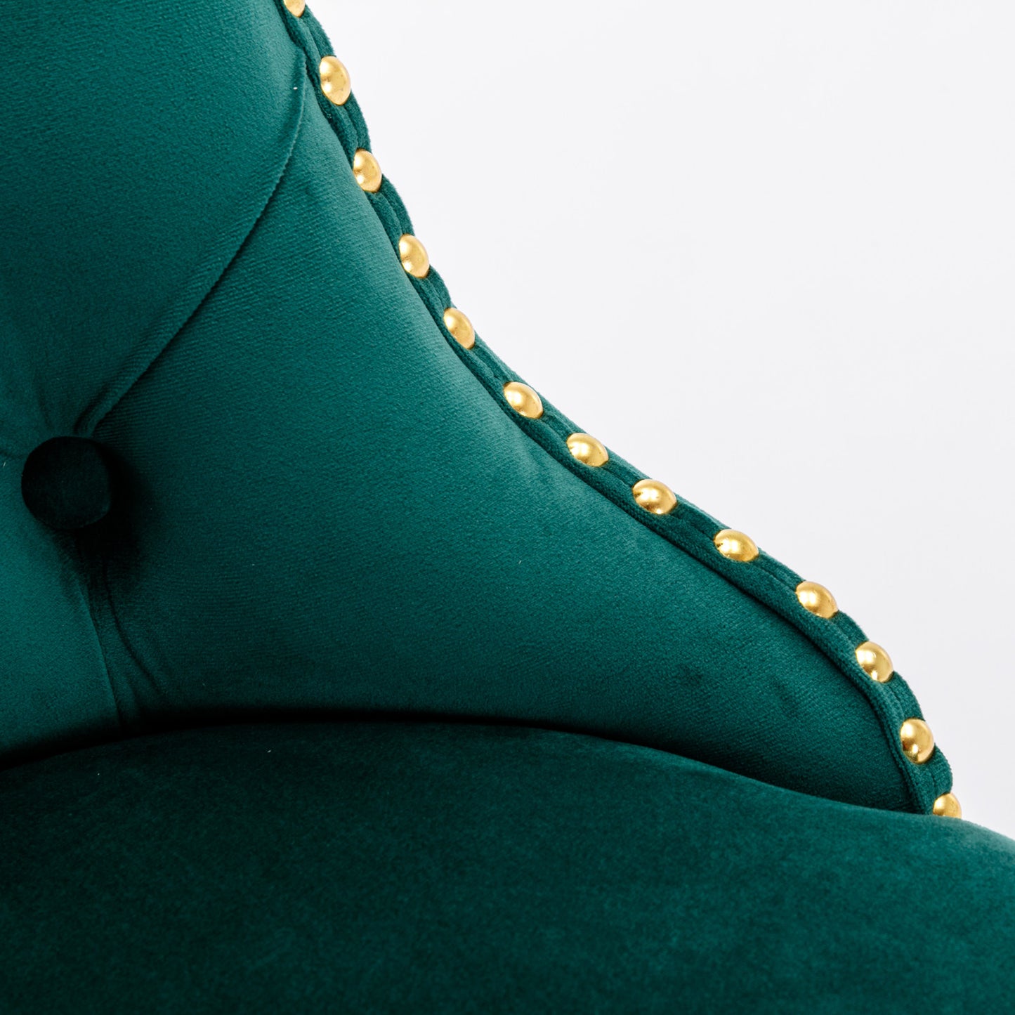 Deep green velvet accent chair with gold studding detail
