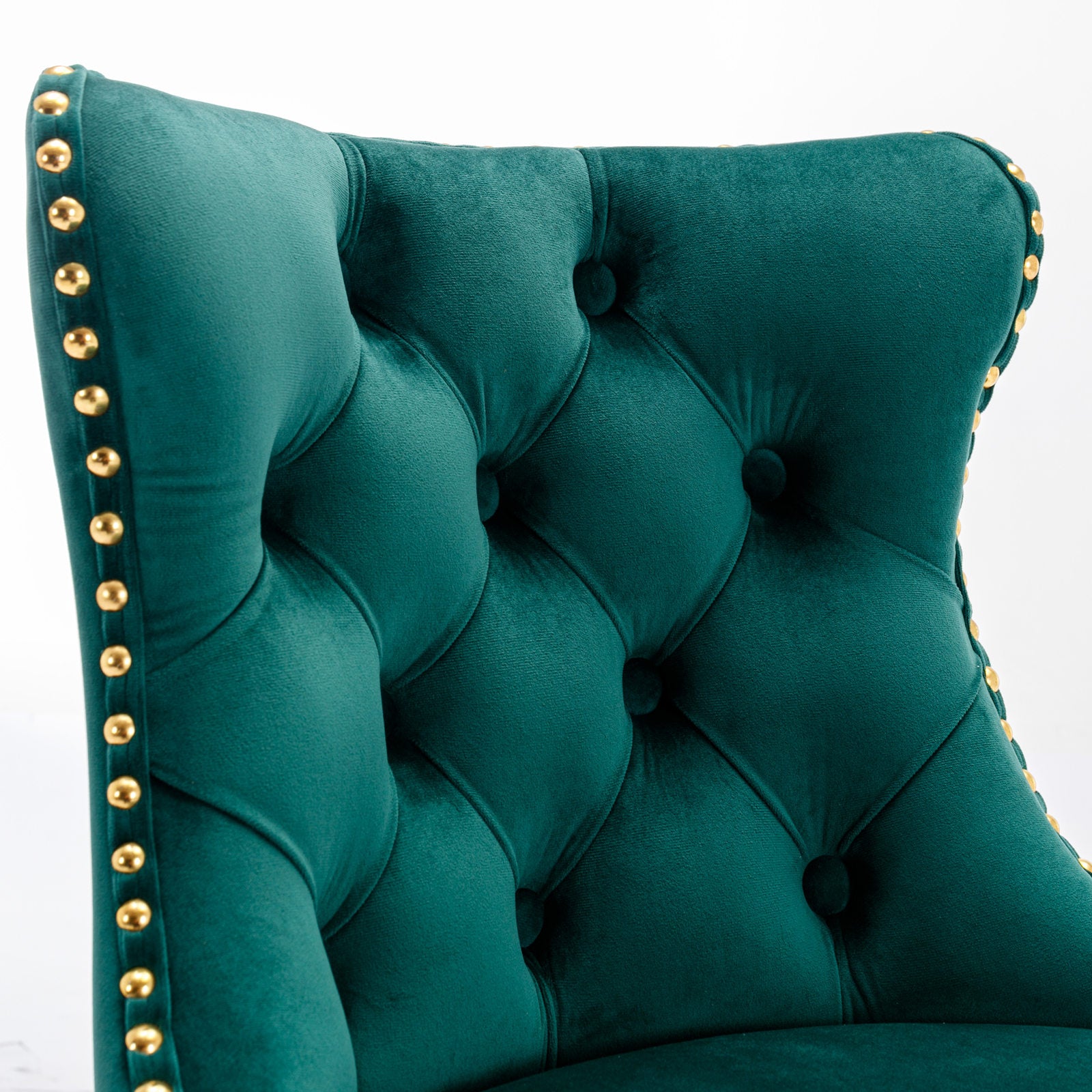 Deep emerald velvet armchair with gold studded trim and tufted back