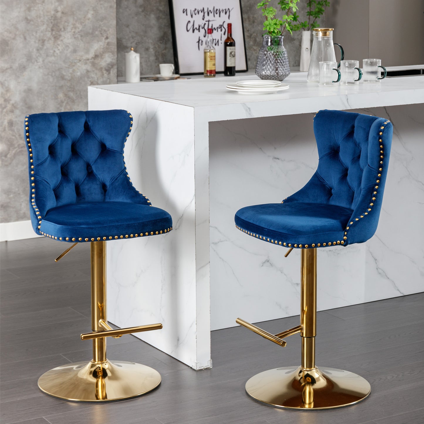 Tufted sapphire blue velvet bar stool with gold nailhead trim and adjustable gold base
