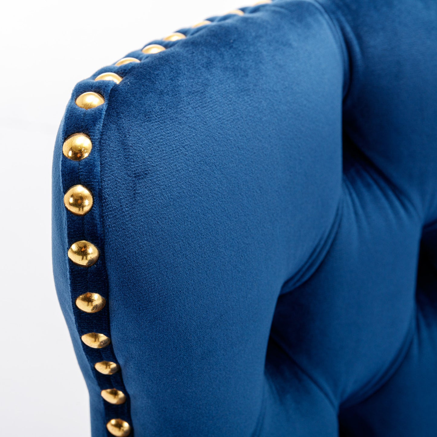 Deep blue velvet armchair with gold nailhead trim