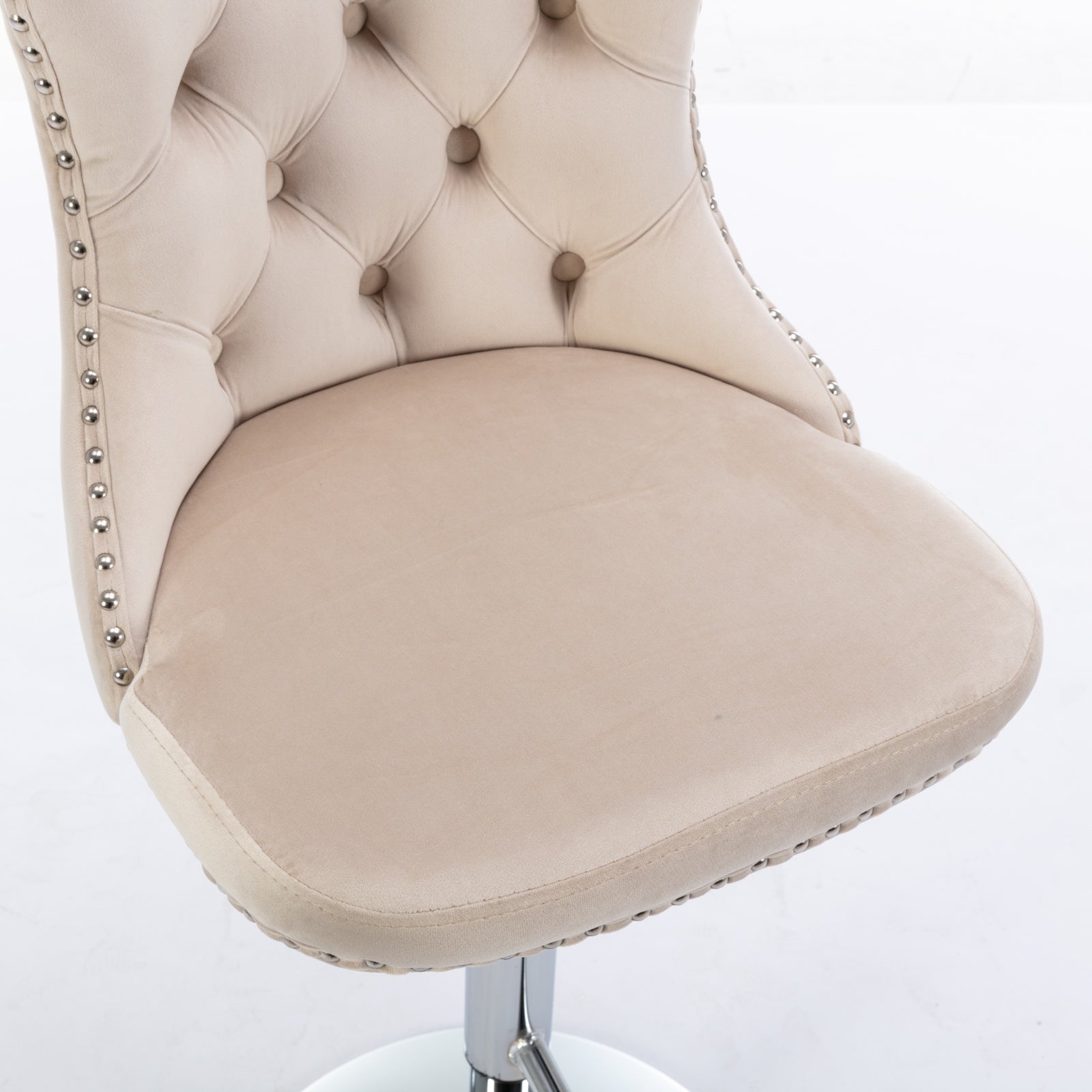 Beige velvet tufted bar stool with chrome nailhead trim and adjustable height base