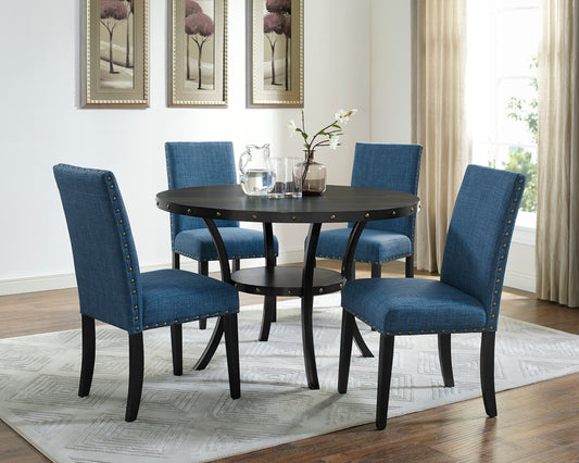 Round dark wood dining table with blue upholstered chairs and brass studs
