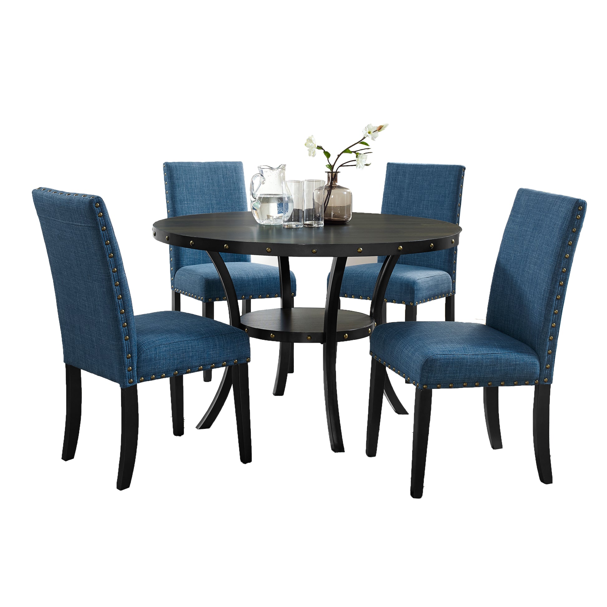 Round dining table with four blue upholstered chairs with nailhead trim