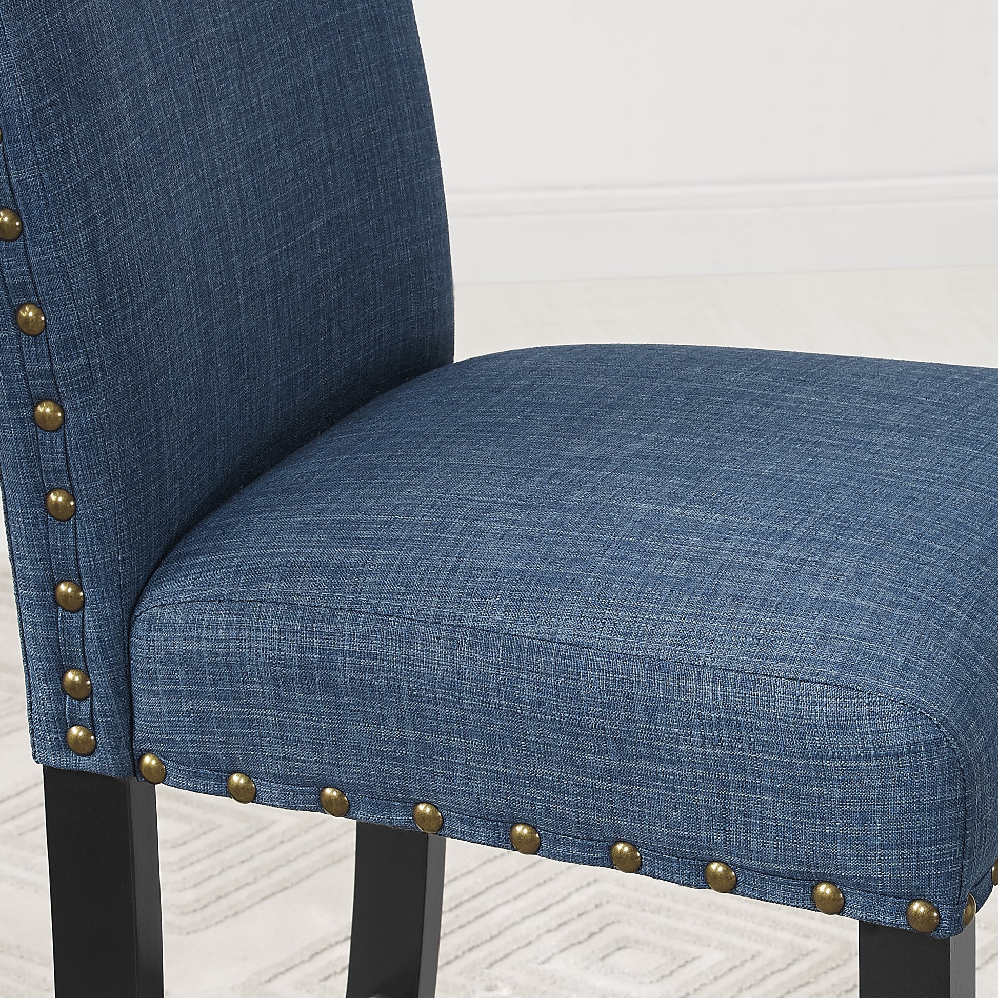 Blue fabric dining chair seat with brass nailhead trim