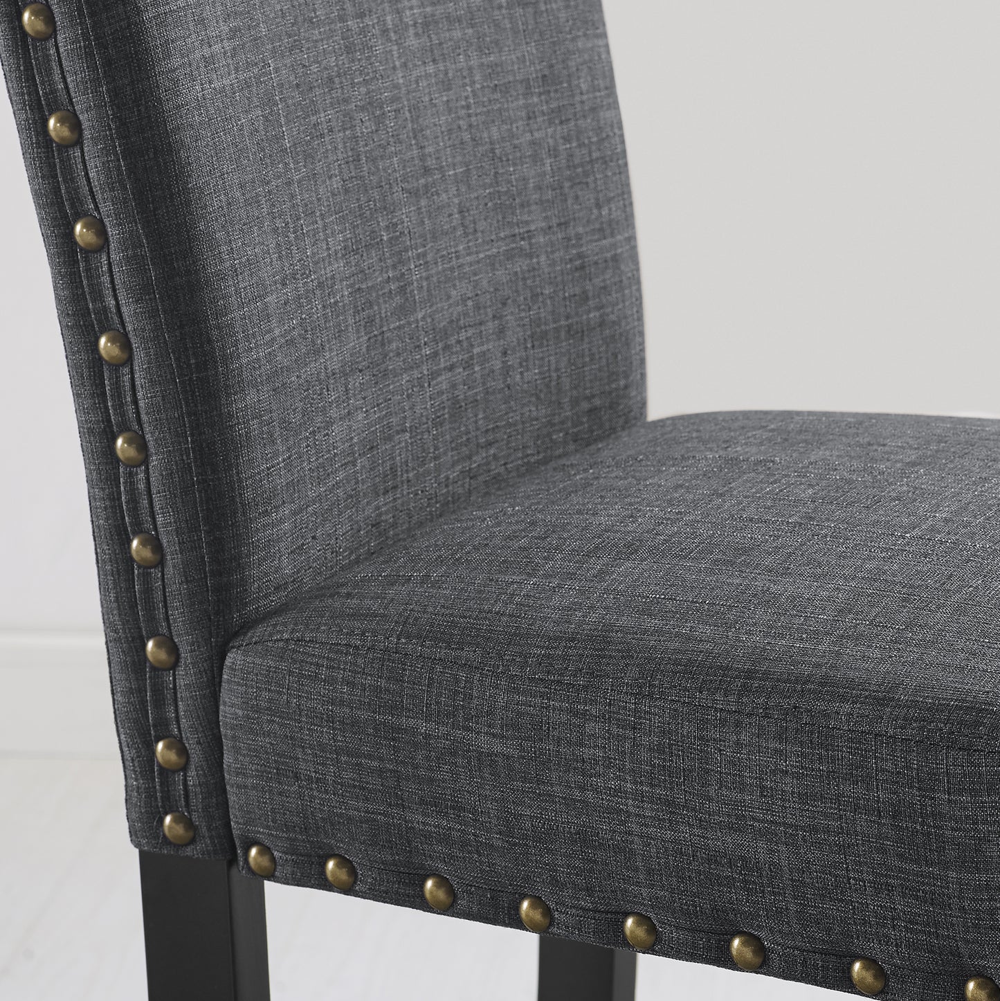 Dark grey fabric dining chair with antique brass nailhead trim