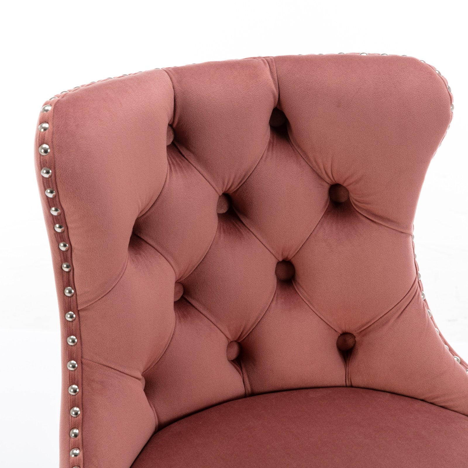 Rose velvet dining chair with tufted back and silver nailhead trim