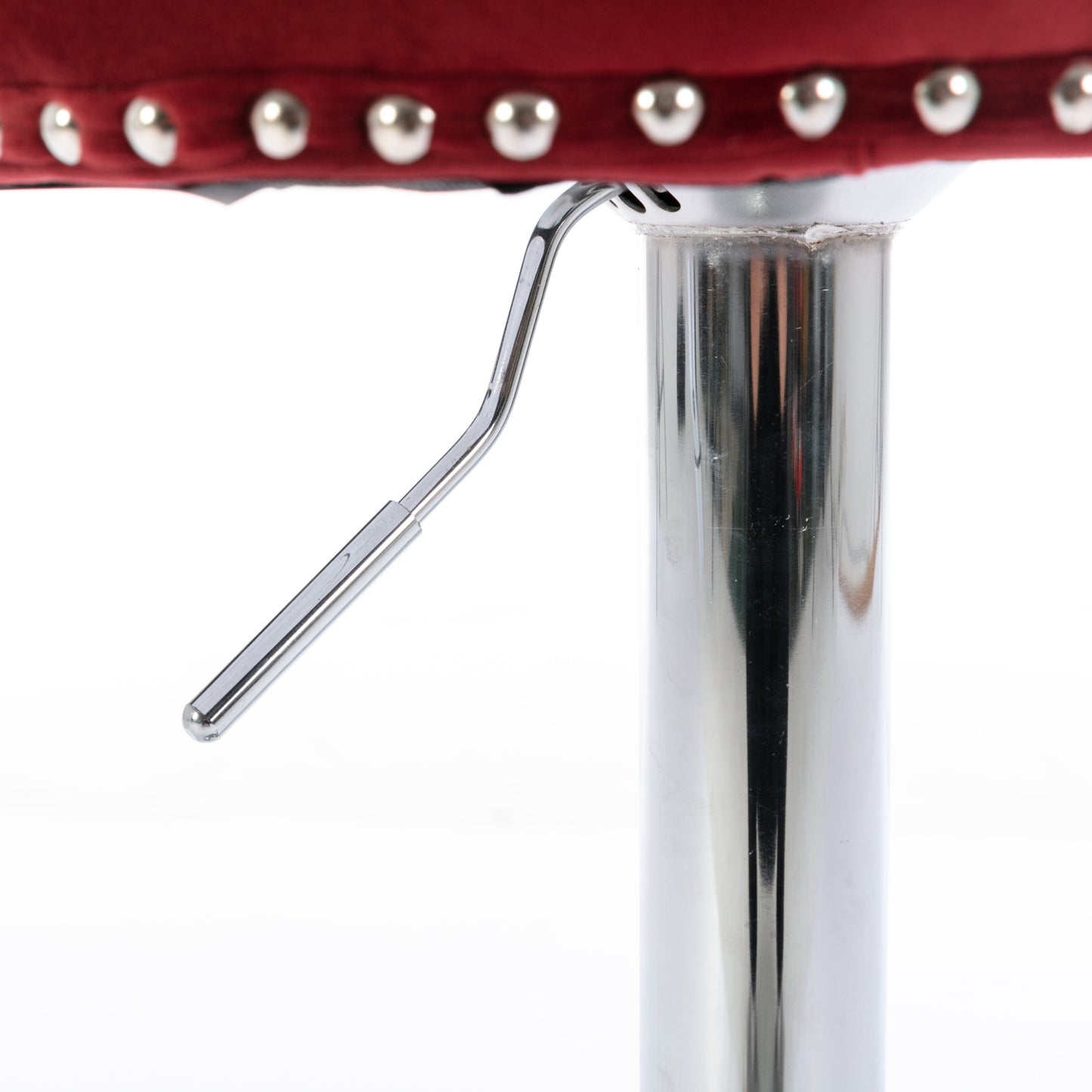 Closeup of tufted burgundy bar stool seat edge with silver nailhead trim