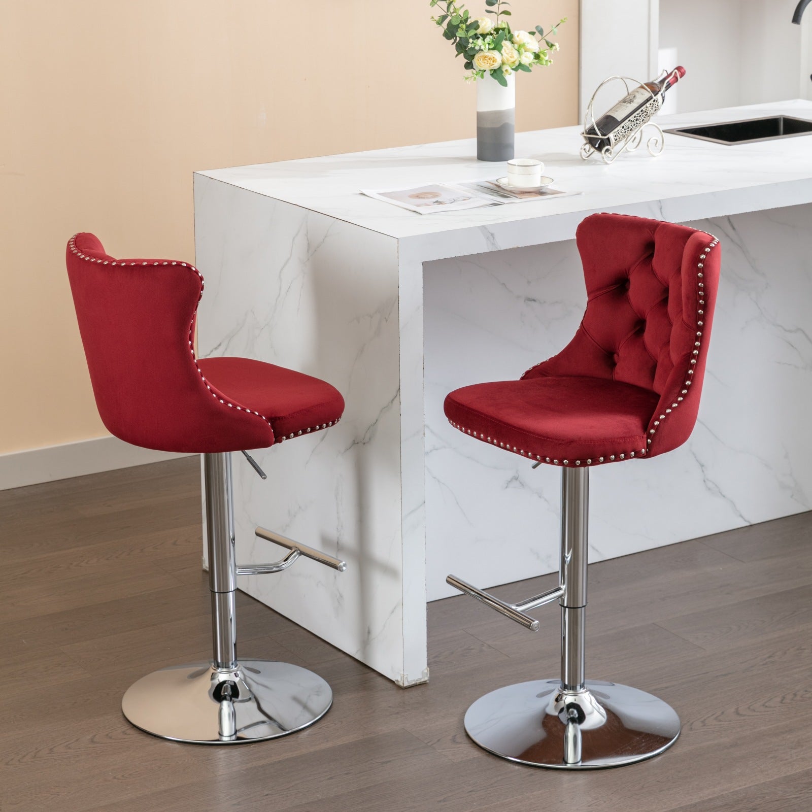 Red velvet bar stool with tufted back and silver nailhead trim