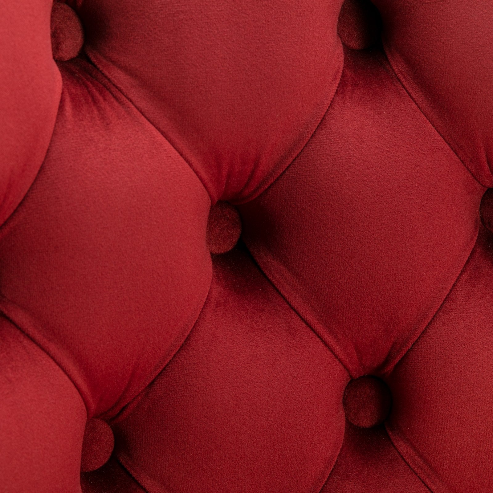Deep red velvet tufted upholstery with diamond quilting