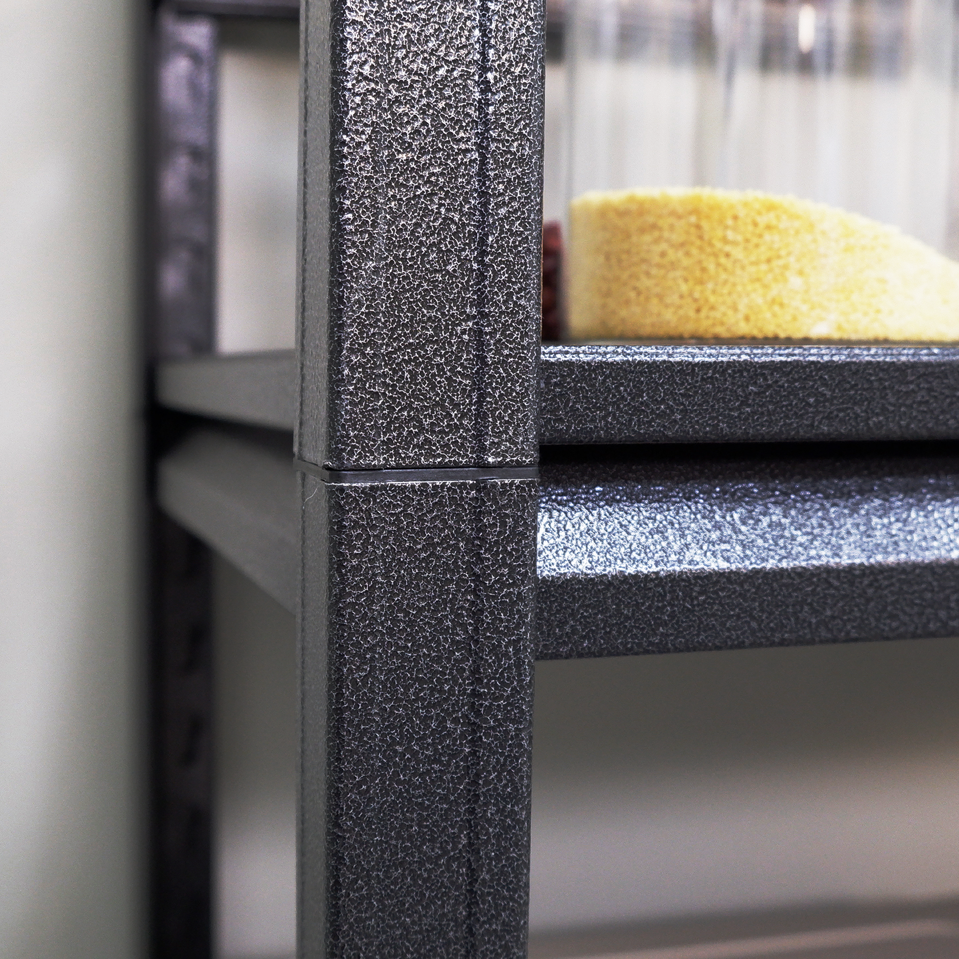 Textured dark grey metal shelving unit