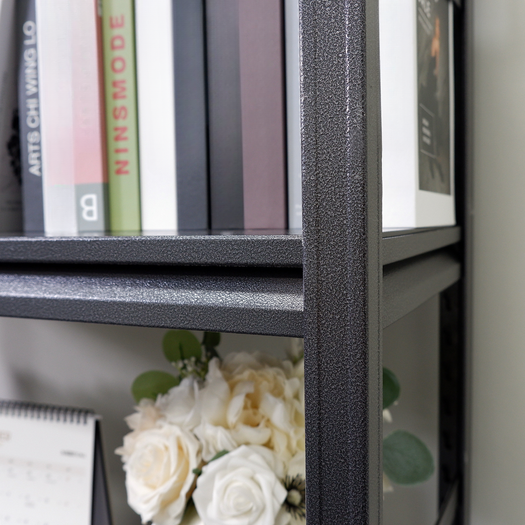 Dark gray metal bookshelf frame with books on top shelf and floral arrangement below