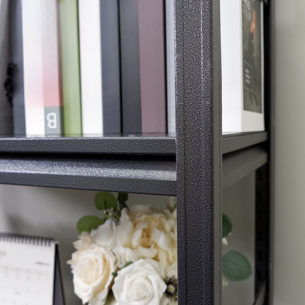 Dark gray metal shelving unit with books and floral arrangement