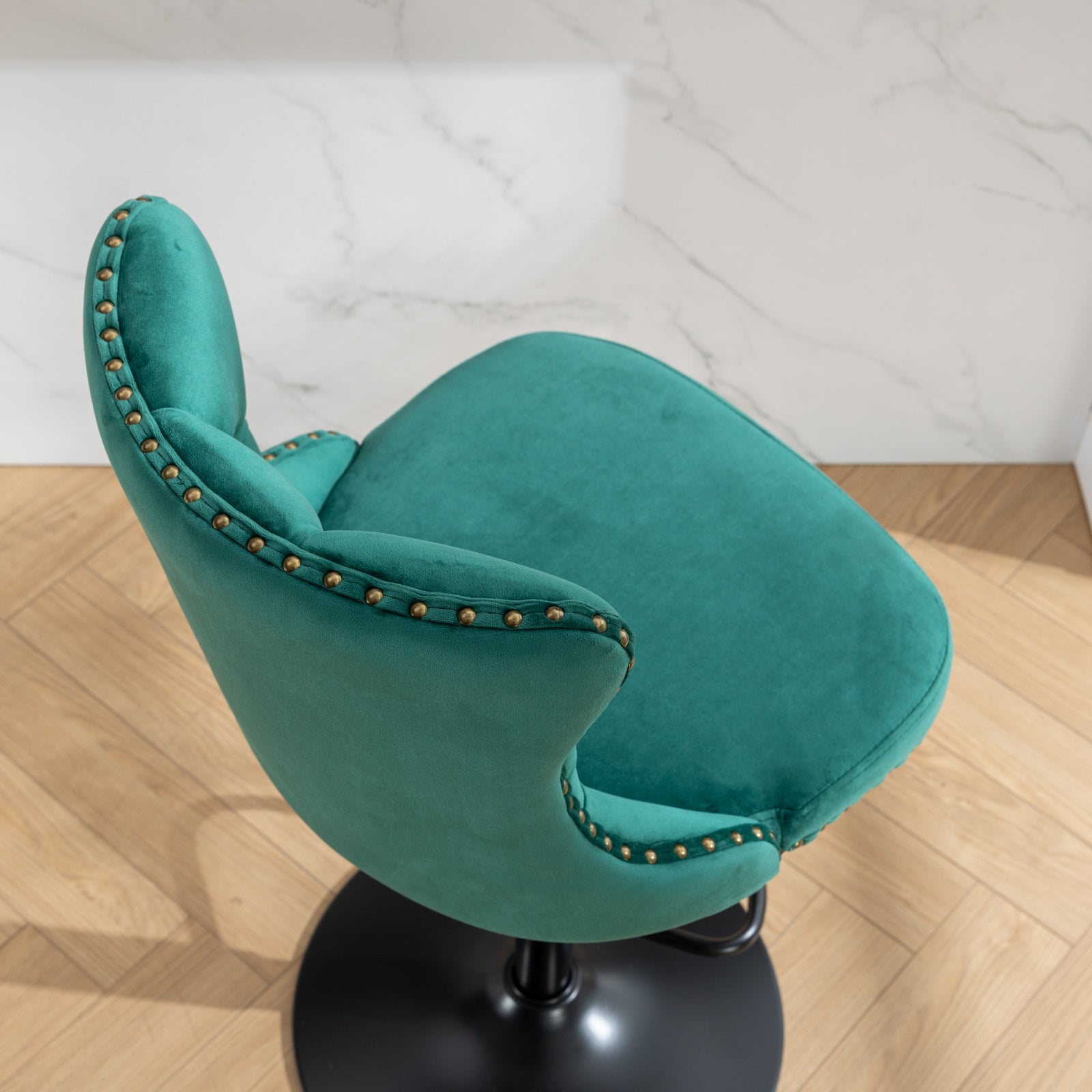 Teal velvet bar stool with gold nailhead trim and black base