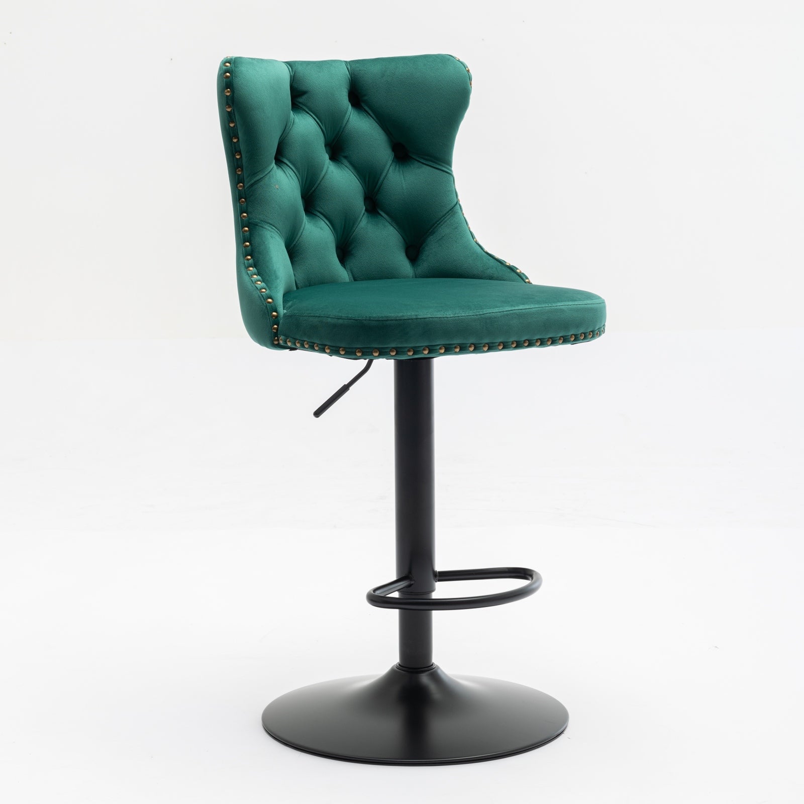 Emerald green velvet tufted bar stool with brass nailhead trim and black metal base