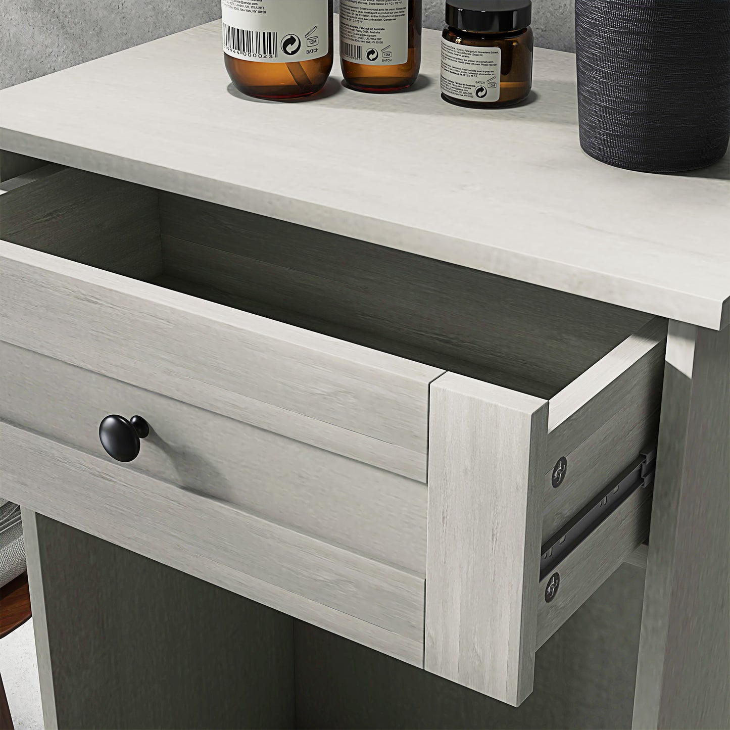 Light grey wood grain bedside table with black drawer knob