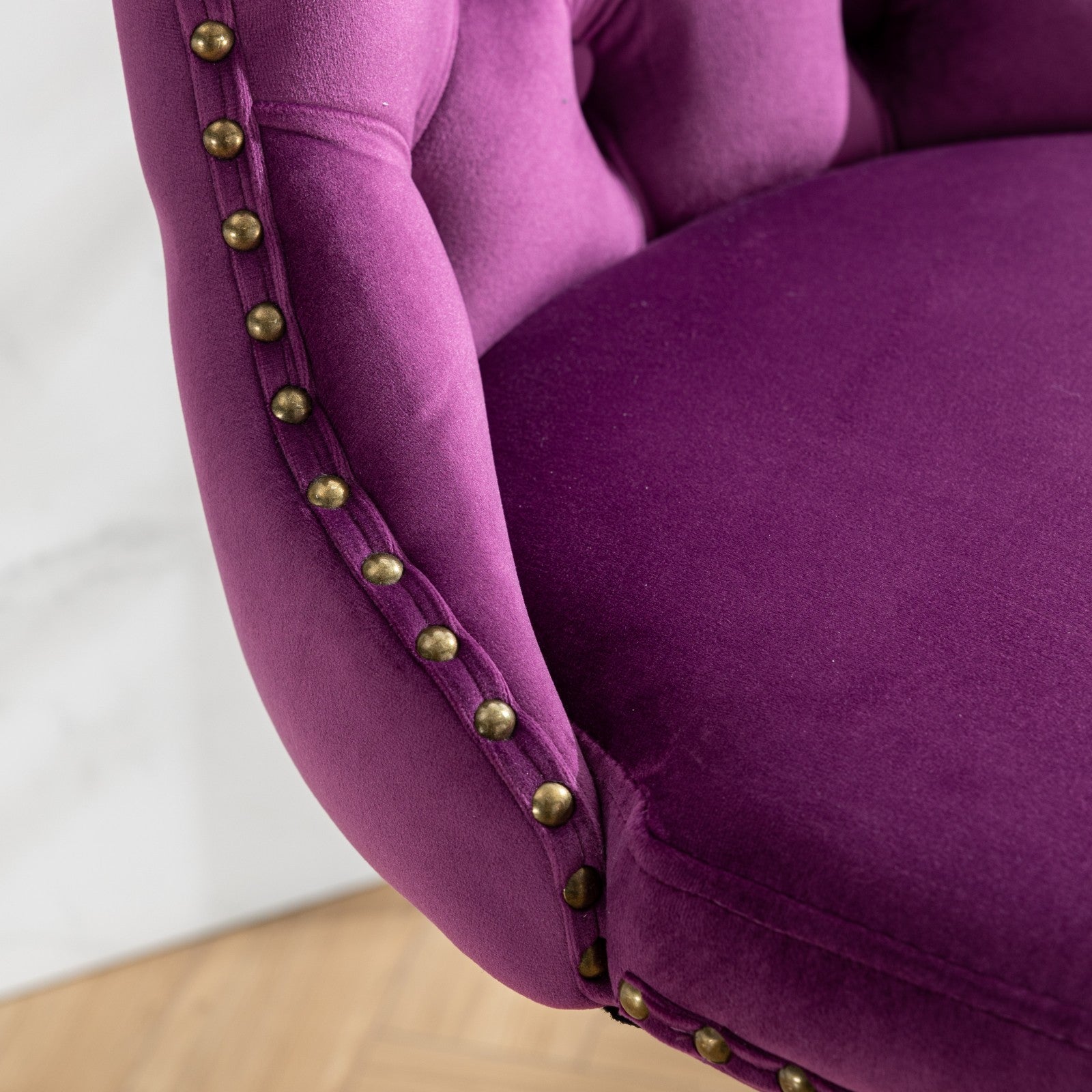 Deep purple velvet armchair with brass nailhead trim