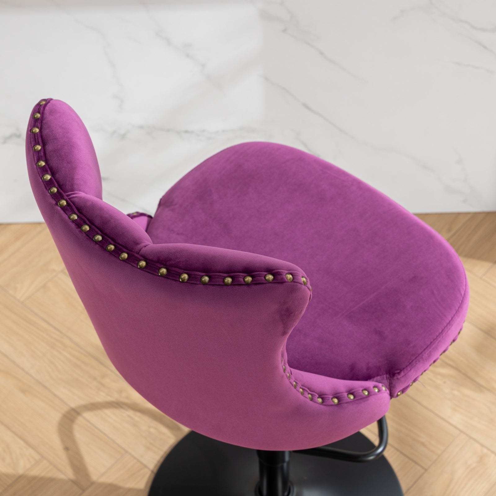 Plush purple velvet accent chair with brass nailhead trim