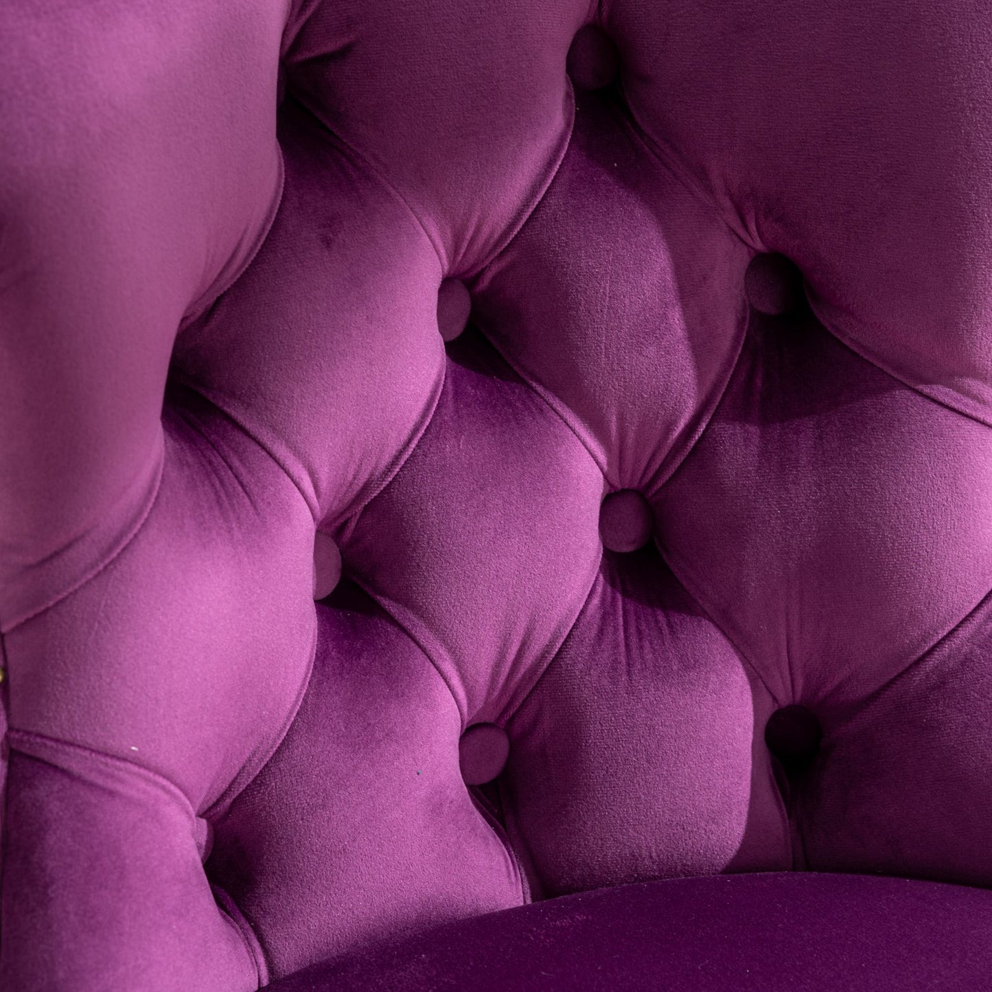 Closeup of plush purple velvet tufted armchair back