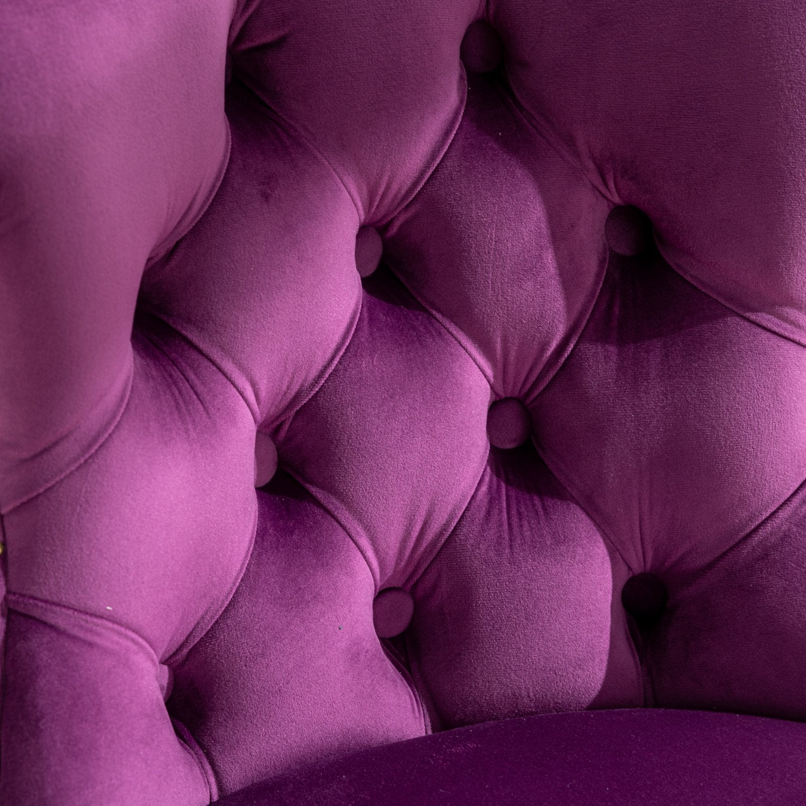 Closeup of plush purple velvet tufted armchair back