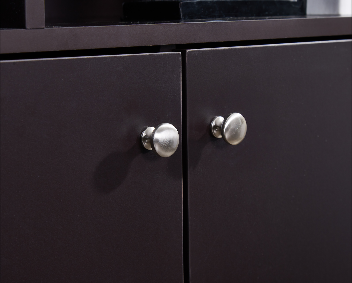 Dark brown cabinet doors with brushed nickel round knobs