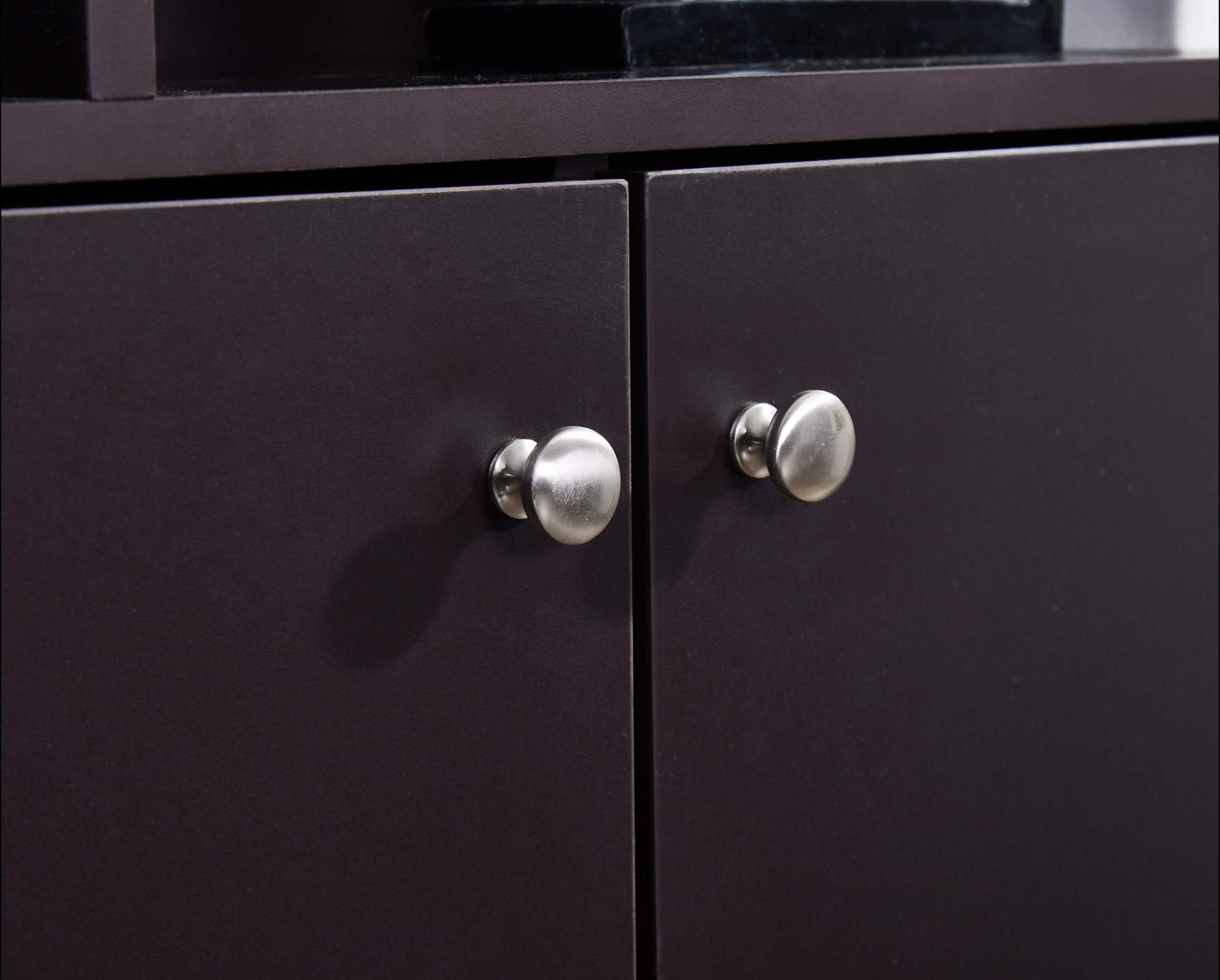 Dark brown cabinet doors with brushed nickel round knobs