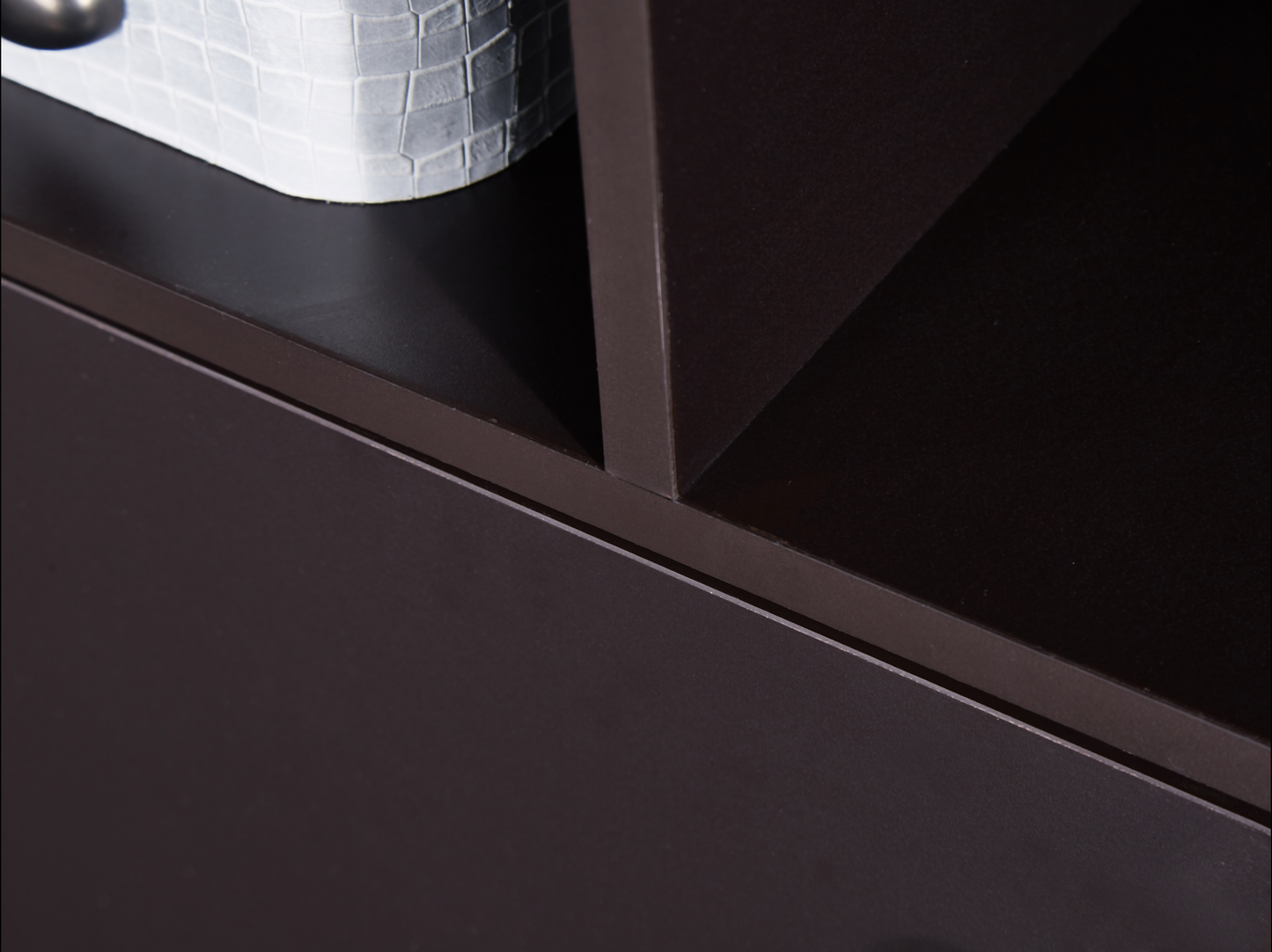 Dark brown modern bookshelf shelf closeup with white textured basket
