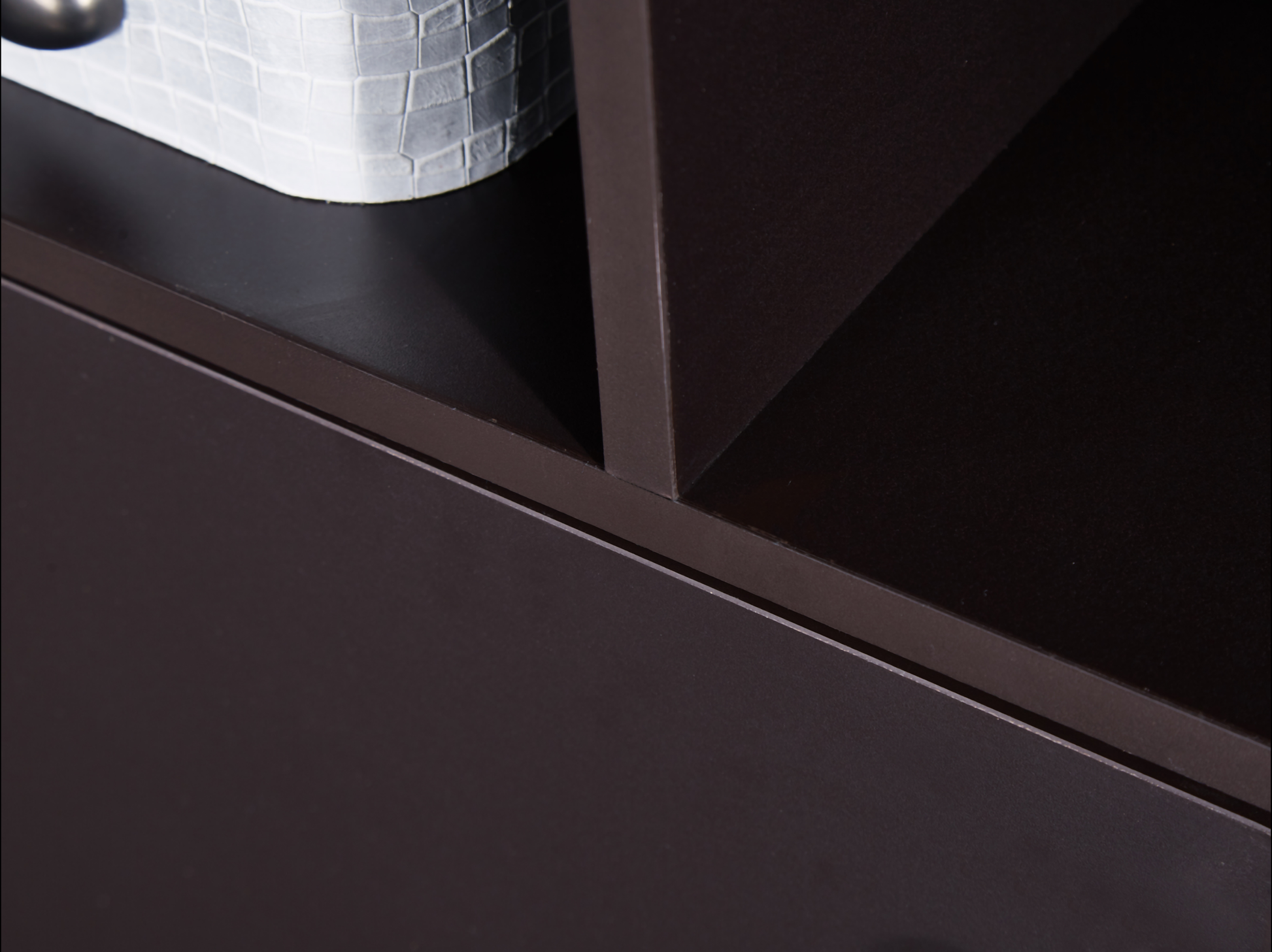 Dark brown modern bookshelf shelf closeup with white textured basket