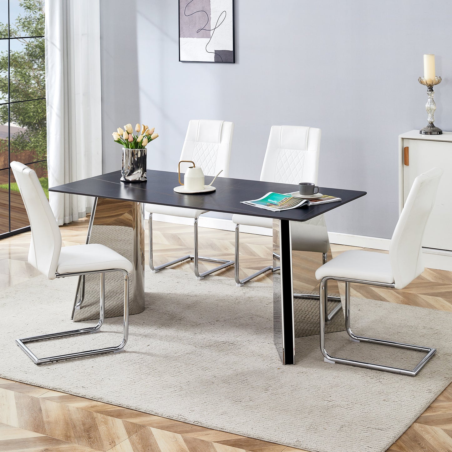 Modern black ceramic dining table with chrome pedestal base and four white faux leather chairs