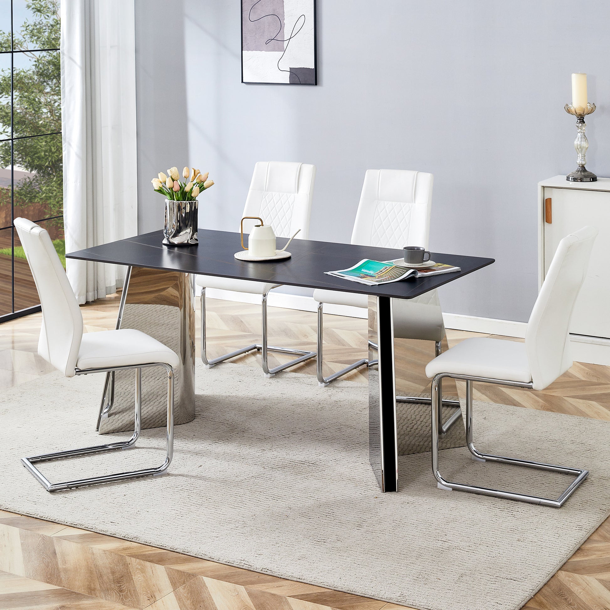 Modern black ceramic dining table with chrome pedestal base and four white faux leather chairs