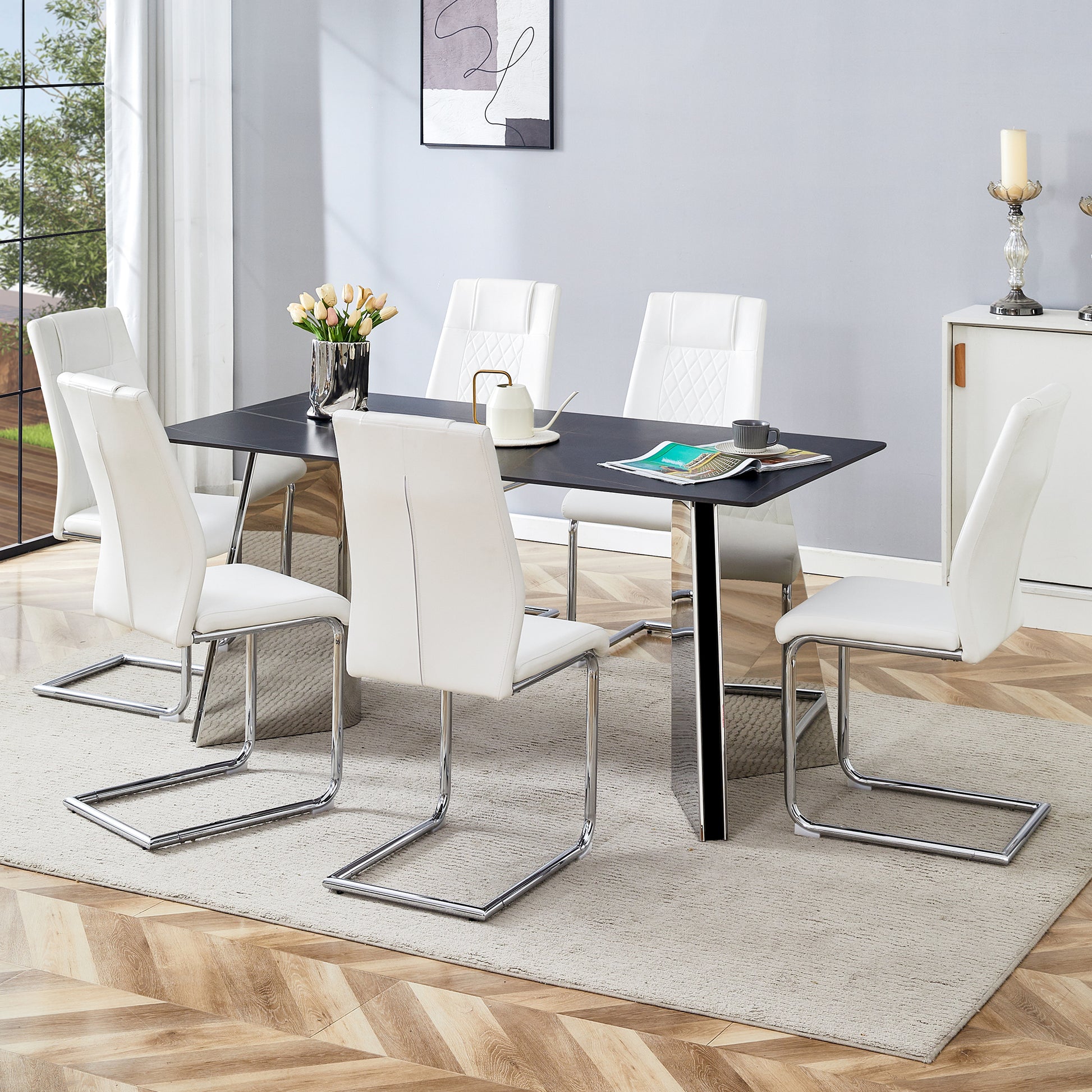 White faux leather dining chairs with chrome legs around a black dining table