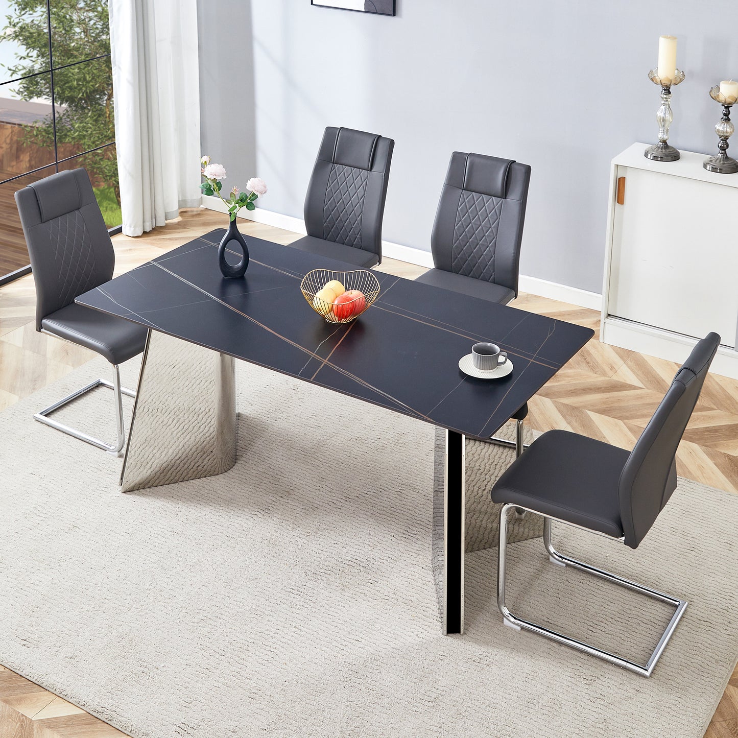 Modern black marble dining table with chrome legs and grey upholstered chairs
