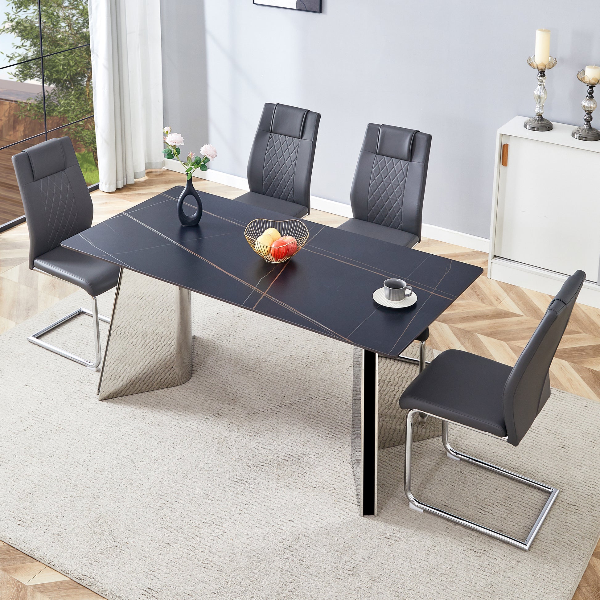 Modern black marble dining table with chrome legs and grey upholstered chairs