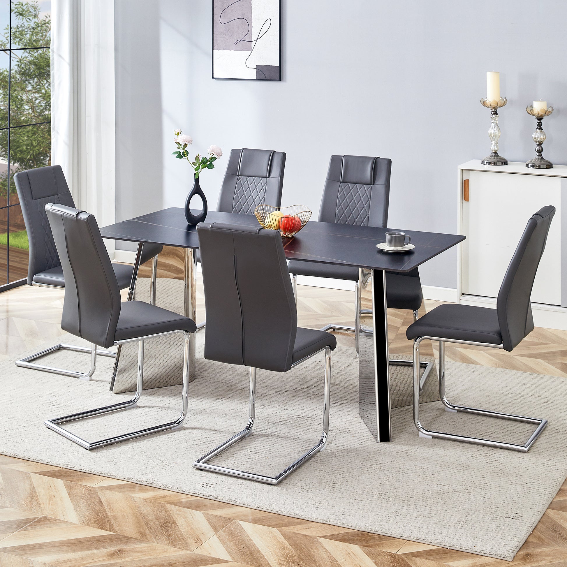 Modern grey faux leather dining chairs with chrome sled legs around a rectangular black table